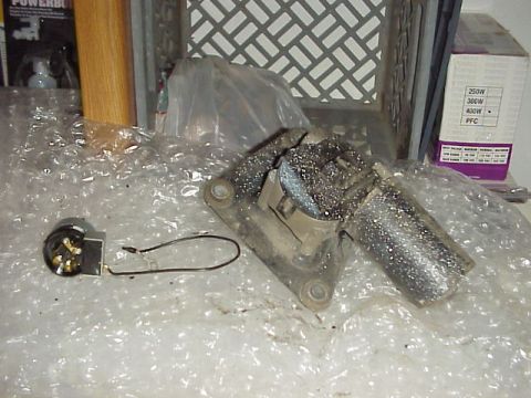 Windshield wiper motor and a small electrical switch with a wire loop
