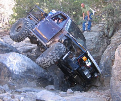 1981 Ford Bronco - This heavily modified truck is attempting to climb a steep, rocky trail.