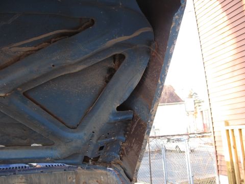 1977 Ford F-150 - The underside of the hood reveals the vehicle's internal structure and some signs of wear.