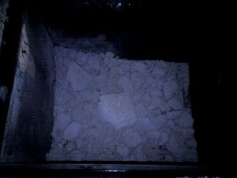 1987 Ford Bronco - The contents of a storage bin appear to be a collection of irregular, light-colored fragments.