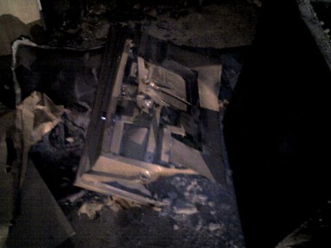 1987 Ford Bronco - The interior of a vehicle shows significant damage and debris, obscuring details of its make and model.