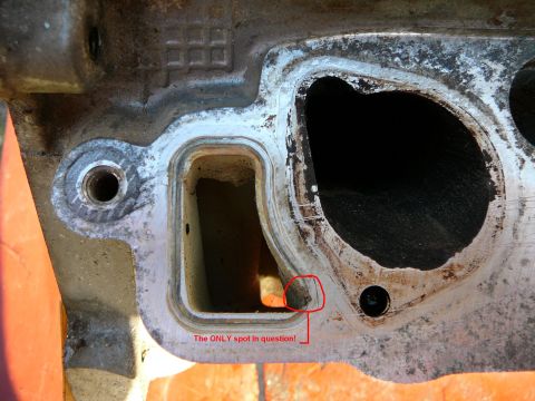 1997 Mercury Grand Marquis - A close-up view of an engine part's gasket surface, with a specific area circled and labeled for inspection.