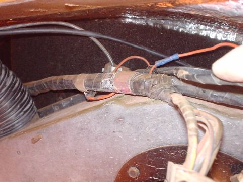 1977 Ford Bronco - Wiring harness detail with electrical tape and conduit, showing a blue connector.