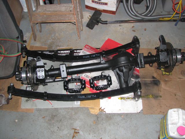 Front axle assembly with leaf springs and brake calipers, labeled MARLIN.INFO.4