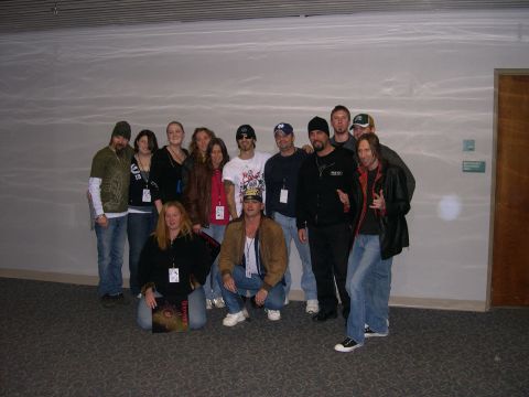 1997 Ford Probe - A group of people, some wearing lanyards, pose for a photo in an indoor setting. One person in the front holds a record album.