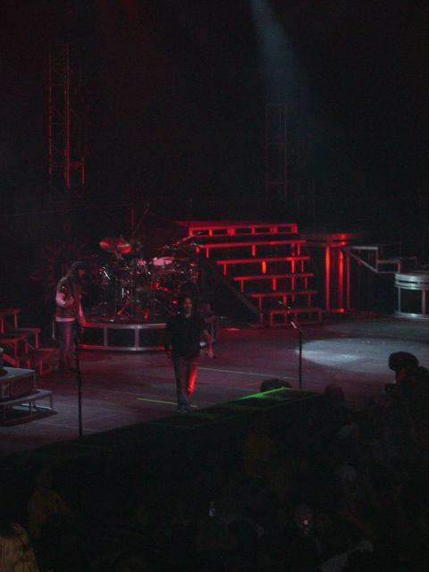 1997 Ford Probe - A concert stage is set up with a drum set and performers under red lighting.