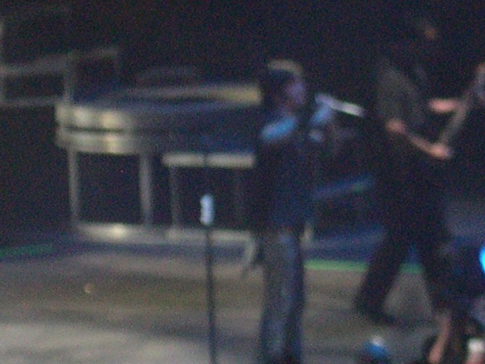 Stage setup with performers and lighting, Supermotors logo at bottom right