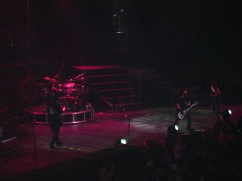 1997 Ford Probe - A band performs on stage with a drum kit and musicians playing guitars.