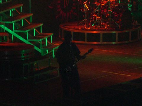 1997 Ford Probe - A musician plays guitar on stage next to a drum set and illuminated stairs during a performance.