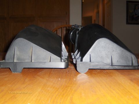 2004 Ford Crown Victoria - Two air intake boxes are shown side-by-side on a wooden surface, with a timestamp visible in the lower left corner.