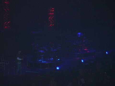 1997 Ford Probe - A concert stage is set up with a drum kit and lighting rig, illuminated by blue lights.