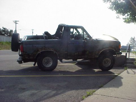 1989 Ford Bronco - This 1989 Ford Bronco is seen from the side, a spare tire on the back.