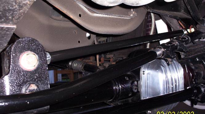 Undercarriage view of front axle with chrome differential cover, black steering linkage and stabilizer