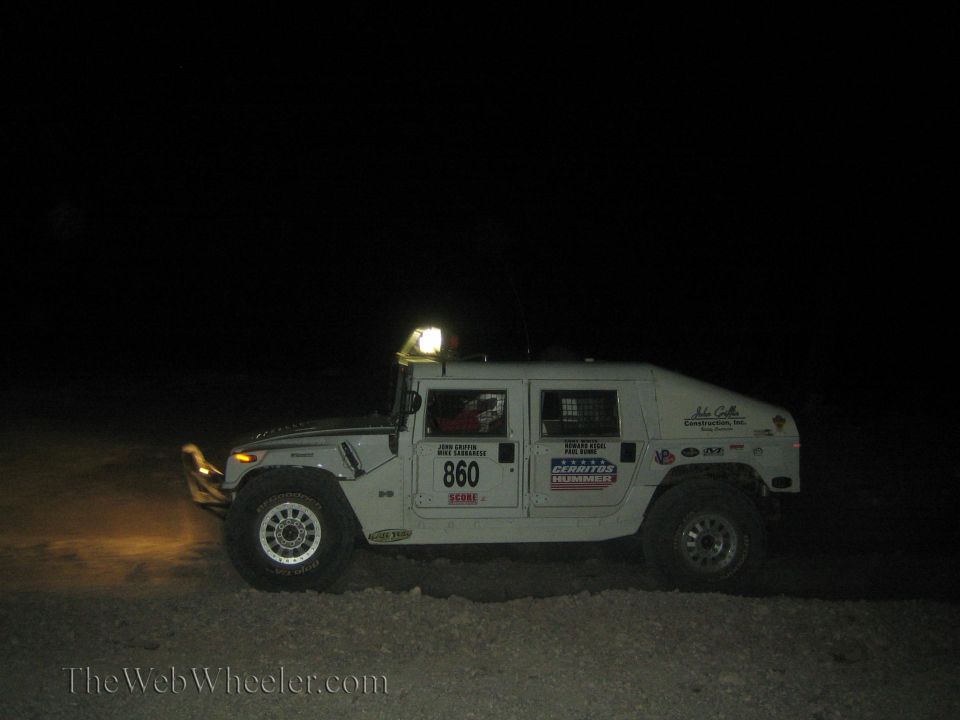 White Hummer H1 race vehicle number 860 at night