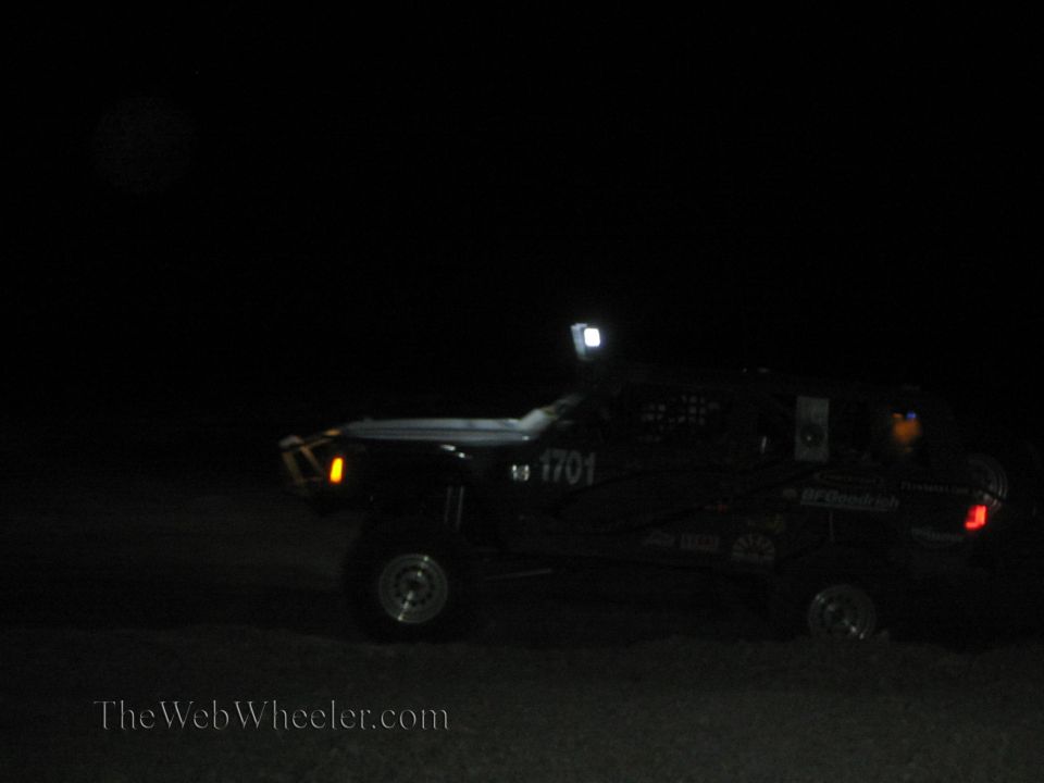 Off-road race truck number 1701 with roof light at night