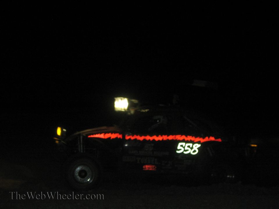 Off-road race car number 558 with red light trim at night