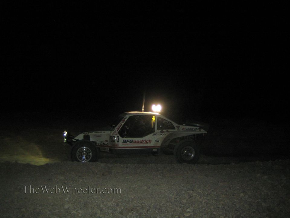 White BFGoodrich-liveried off-road race car at night