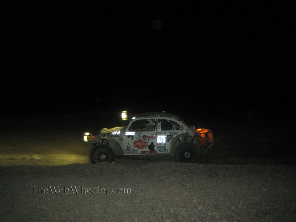 White Baja Bug race car number 575 at night