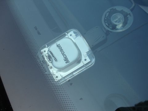 1993 Ford Taurus - Microsoft device with Ford logo is attached to the windshield of a car.
