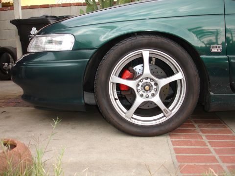 1993 Ford Taurus - Front view of a 1993 Ford Taurus showing the fender, wheel, and brake system with aftermarket Enkei RS5 wheels.