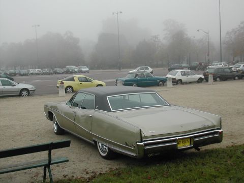 1991 Ford Crown Victoria - Rear view of a 1967 Buick LeSabre on a foggy day, with other vehicles visible.