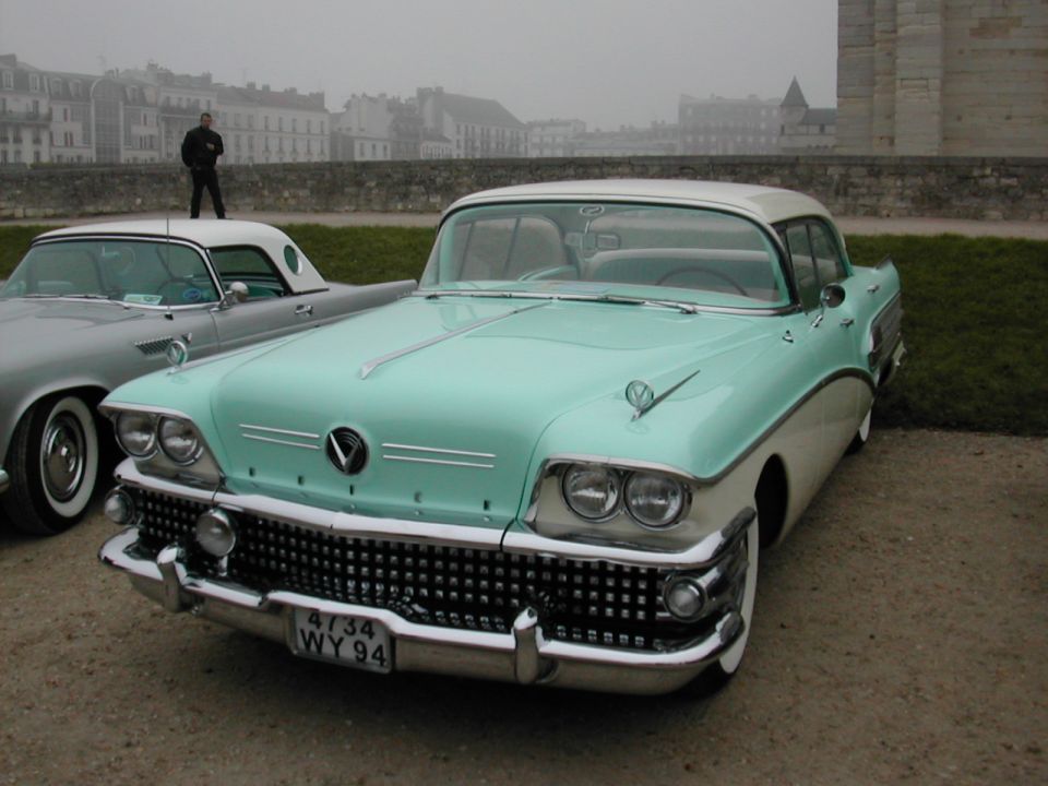 Teal and white two-tone 1958 Buick Century coupe front view, chrome grille, dual headlights, license plate WY94