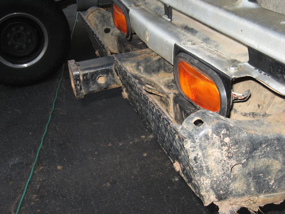 Rear bumper assembly with orange marker lights and a trailer hitch receiver