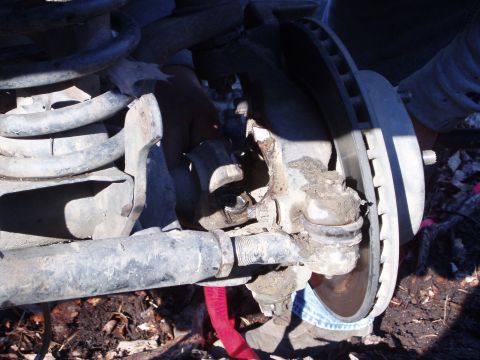 1989 Ford F-350 - Detail of a vehicle's front suspension system, showing various mechanical parts.