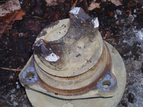 1989 Ford F-350 - This broken metal component, likely from a vehicle's drivetrain, shows significant damage and wear.