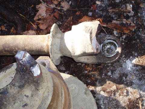 1989 Ford F-350 - A close-up view of a damaged driveshaft component, suggesting a need for repair or replacement.