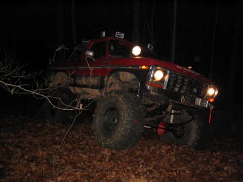 1979 Ford Bronco - This modified SUV is equipped with off-road lights and large tires, ready for nighttime trail use.