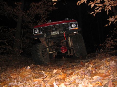 1979 Ford Bronco - This lifted 1979 Ford Bronco navigates a dark, wooded trail covered in fallen leaves.