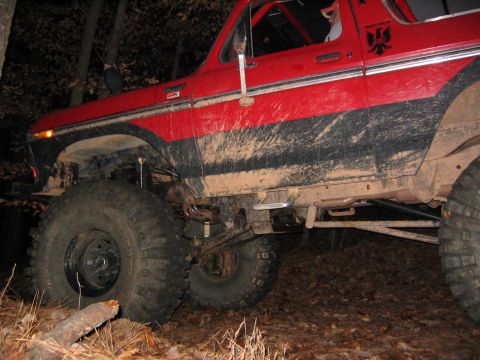 1979 Ford Bronco - This mud-covered SUV, likely a 1978 model, is equipped for off-road adventures.