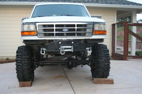 1992 Ford Bronco - This heavily modified Ford truck features an aftermarket winch and suspension system, obscuring its original model year.