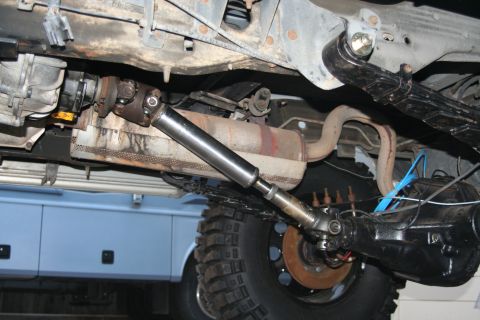 1992 Ford Bronco - Close-up view of the underside of a vehicle, focusing on the mechanical components of the drivetrain.