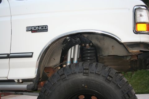 1992 Ford Bronco - Close-up of the front fender and suspension system on a 1992 Ford Bronco XLT.
