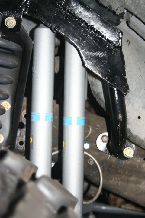 1992 Ford Bronco - This image shows aftermarket Bilstein shocks installed on a vehicle's suspension system.