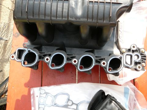 1997 Mercury Grand Marquis - Engine intake manifold and associated gaskets are shown, likely for replacement.