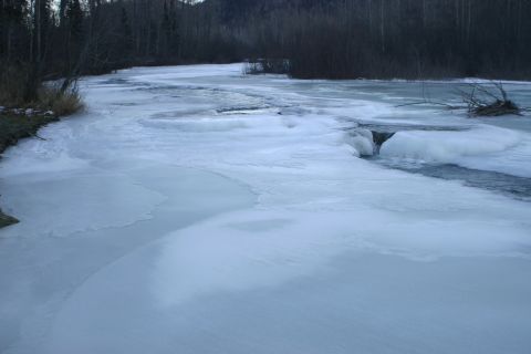 2003 Jeep TJ - Winter scene of a partially frozen river with ice along the banks and in the water.