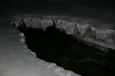 2003 Jeep TJ - Winter scene shows a frozen stream bank with icicles and dark water.