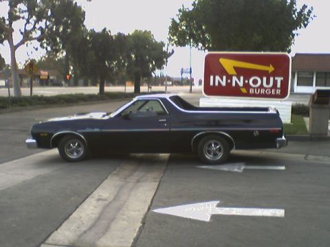 1973 Ford Ranchero - Side view of a black 1973 Ford Ranchero parked near an In-N-Out Burger restaurant.