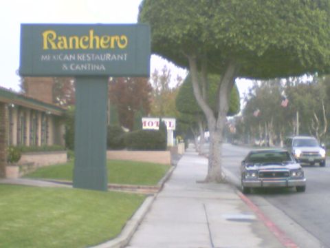 1973 Ford Ranchero - A sign for a Mexican restaurant is visible on the left, with cars driving down the street on the right.