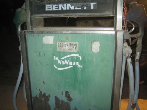 1990 Ford Bronco - Close-up of a weathered green Bennett fuel pump body showing a Hardy decal and peeling paint in dim light.