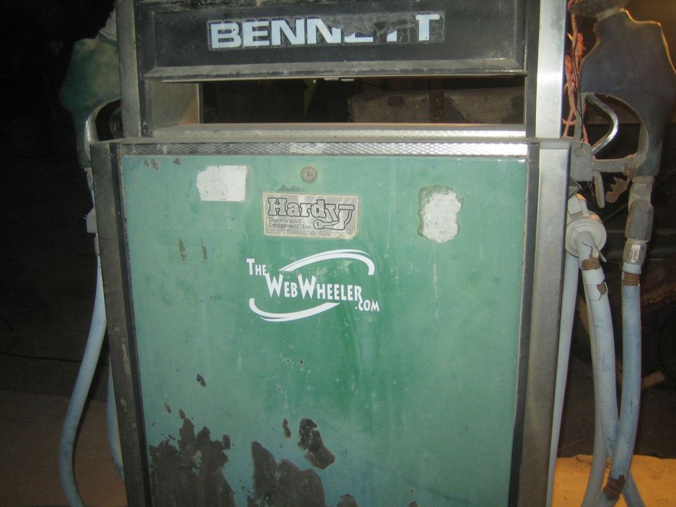 Close-up of weathered green Bennett fuel pump with Hardy decal