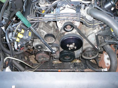 1997 Mercury Grand Marquis - Step 5: Insert a 1/2 nich drive breaker bar into the tensioner pulley as indicated. Rotate handle clockwise to release tension on the belt.…