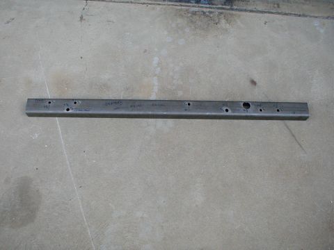 1996 Ford Bronco - A metal bracket with multiple holes and handwritten markings, likely a custom part for a vehicle project.