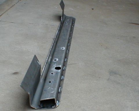 1996 Ford Bronco - A fabricated metal slider rail component rests on a concrete surface.