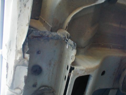 1996 Ford Bronco - Close-up view of a heavily rusted and damaged vehicle frame section, showing signs of cutting and wear.
