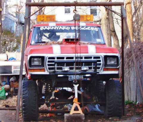 1978 Ford Bronco - This lifted pickup truck is suspended by a hoist for maintenance or modification.