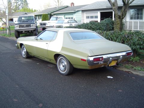 1973 Ford Torino - This two-tone Ford Torino is parked on a residential street with other vehicles visible.